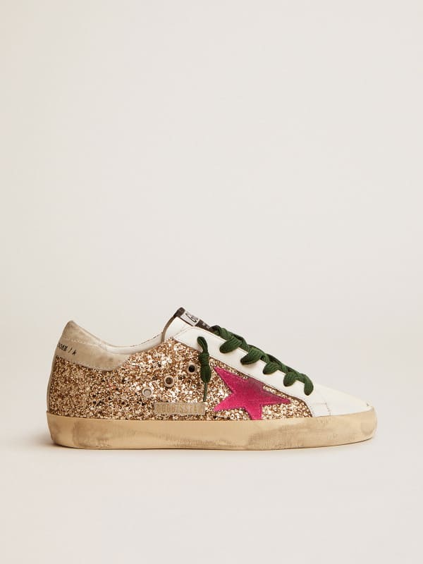 Super-Star sneakers in gold glitter with fluorescent pink suede star |  Golden Goose