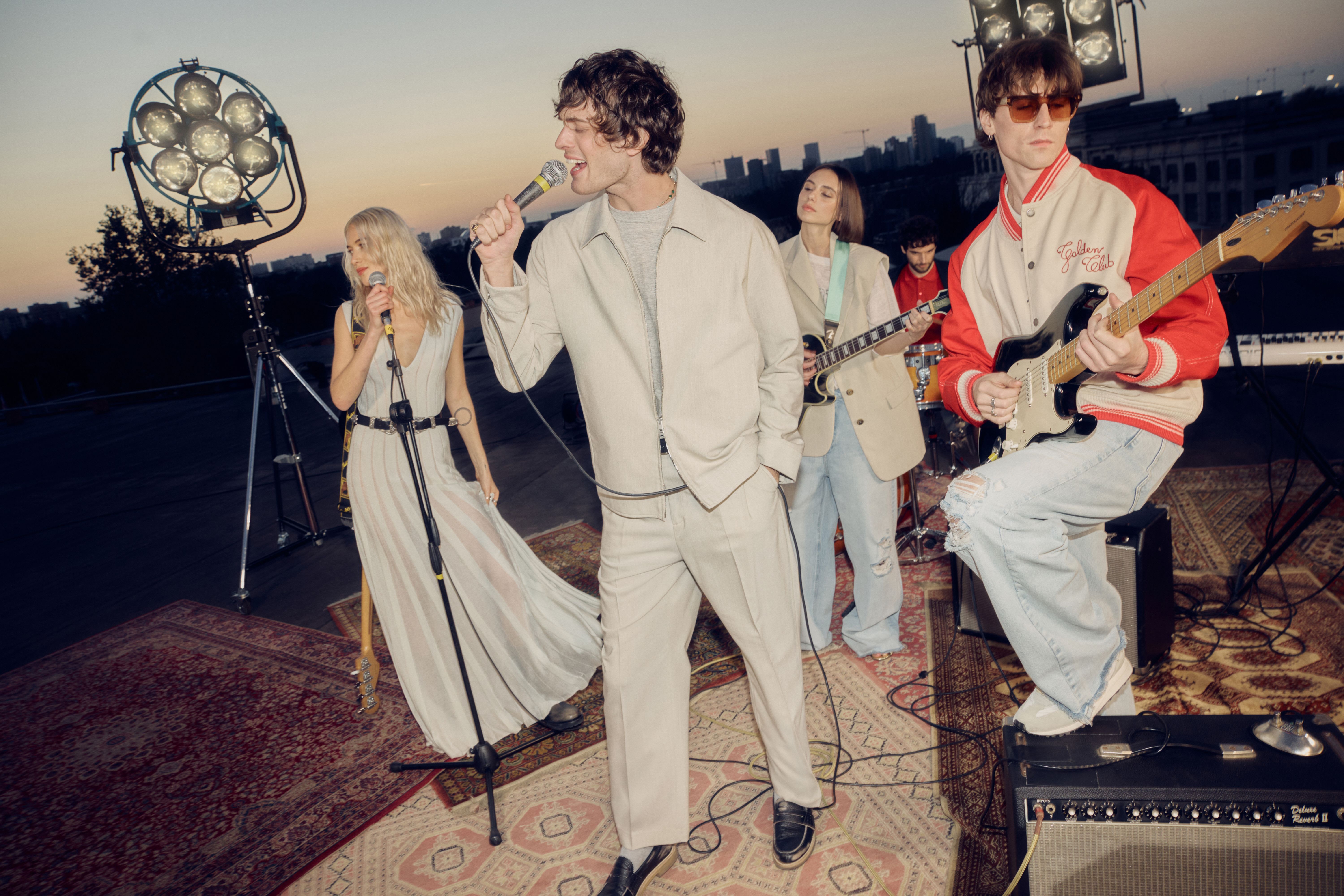 group-of-friends-singing-and-playing-instruments-on-a-rooftop