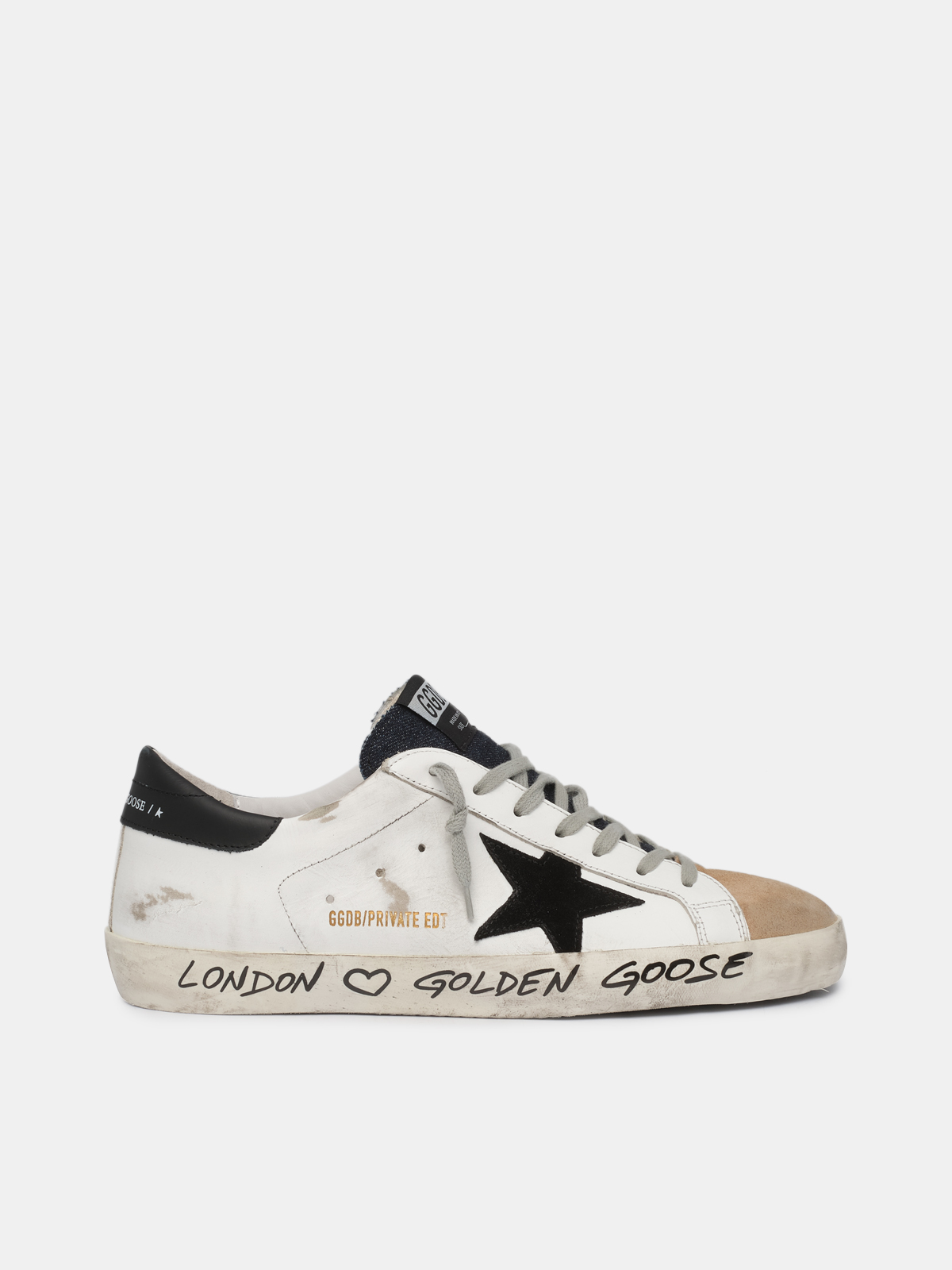 White beige sneakers with handwritten wording Golden Goose