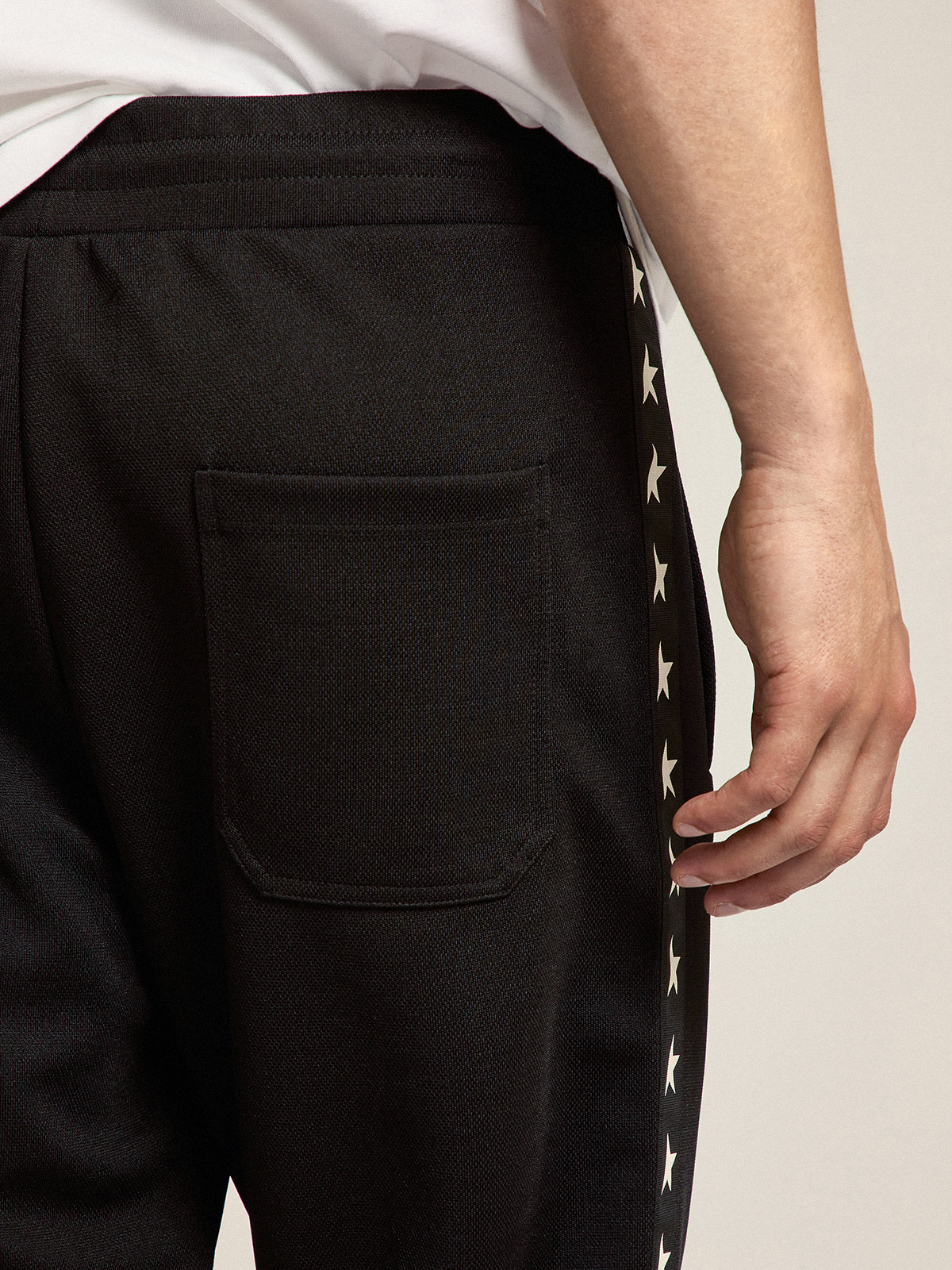 Men's black joggers with white stars on the sides | Golden Goose