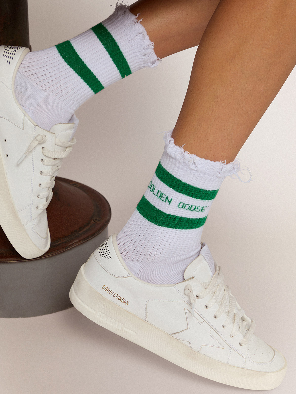 Cotton socks with distressed finishes, green stripes and logo