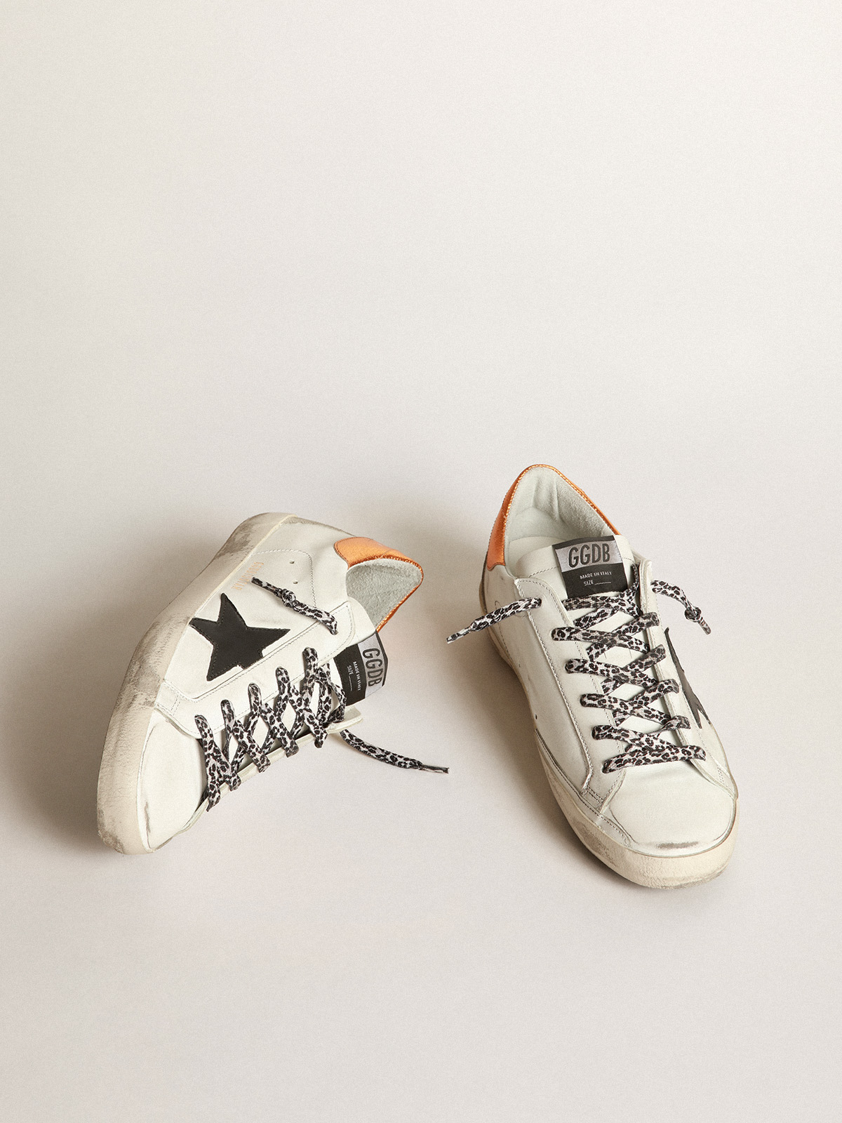 White Super-Star sneakers with black star and leopard-print laces