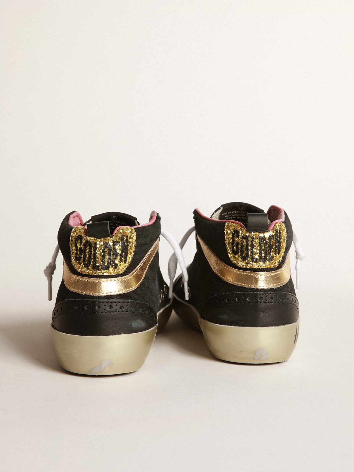 Black sneakers with gold-coloured inserts and glitter | Golden Goose