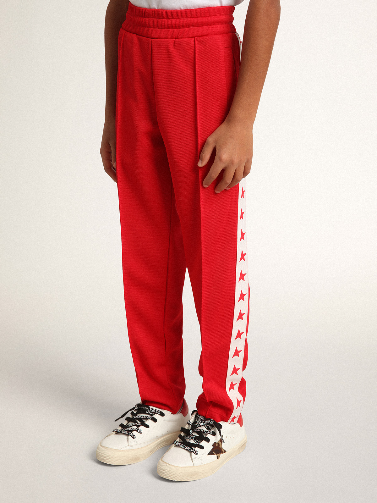 Red track pants store with white stripe