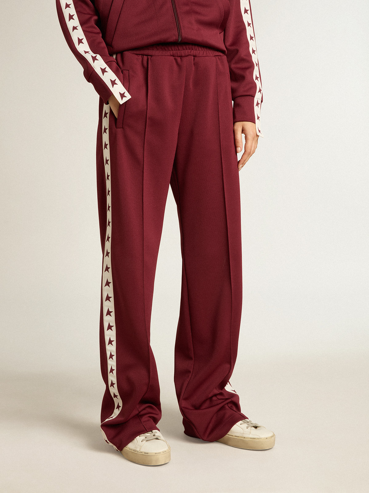 Women's red joggers with stars on the sides