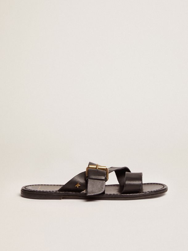 Women's flat sandals in black resin-coated leather
