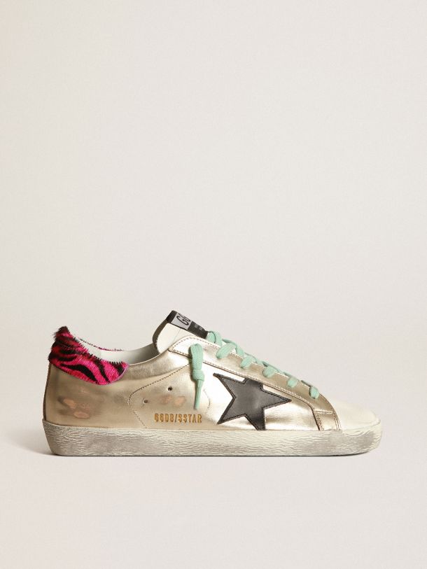 Golden Goose - Gold Super-Star sneakers with zebra-print heel tab in 