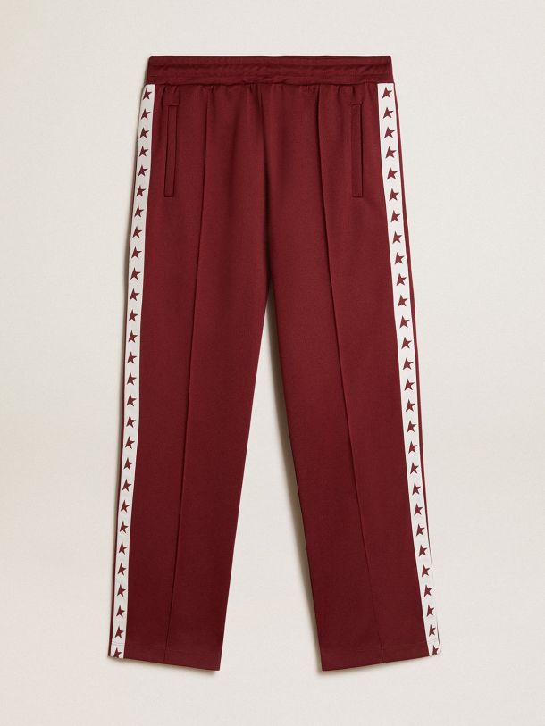 Men’s burgundy joggers with stars on the sides