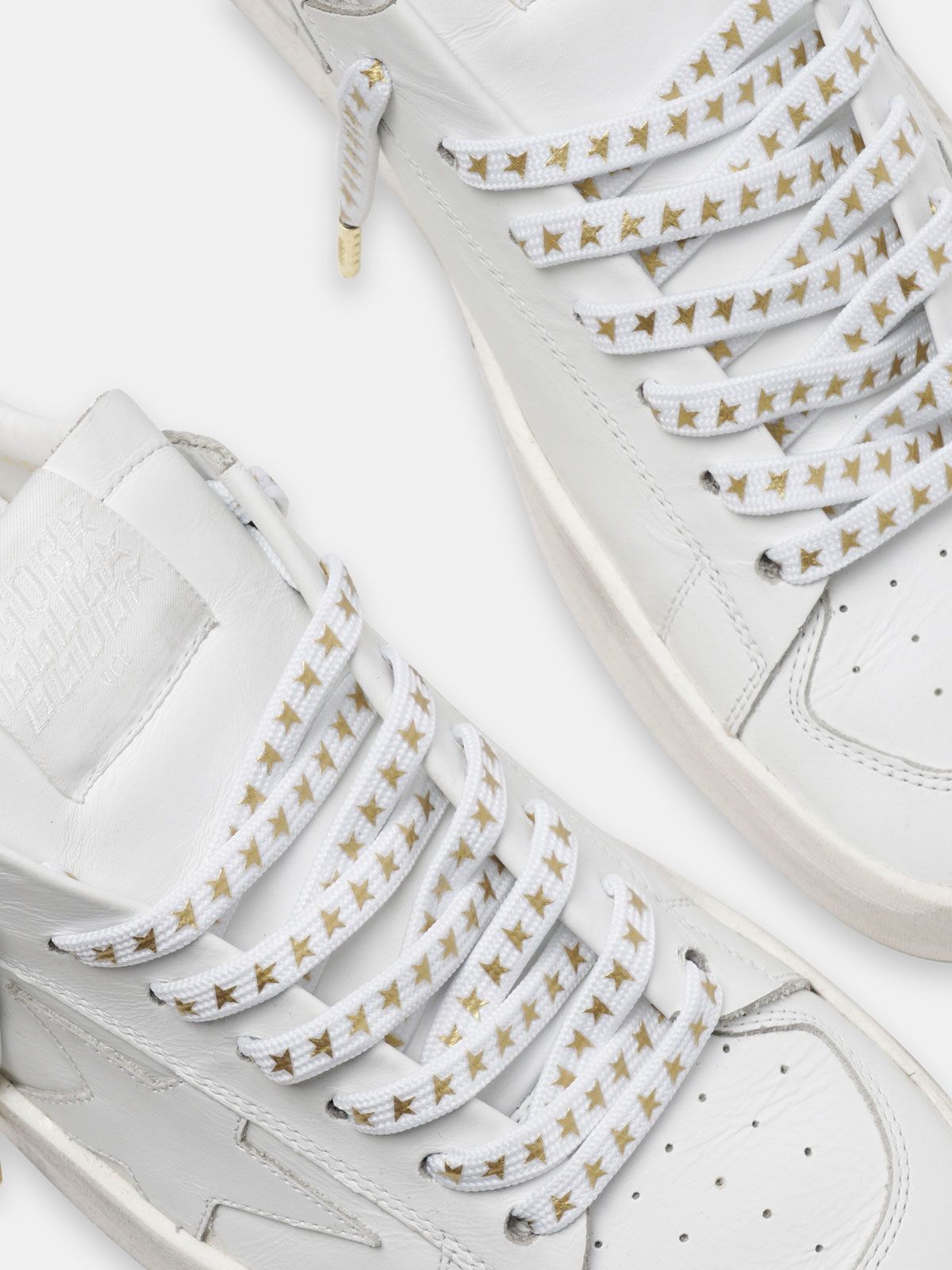 white shoes with gold stars