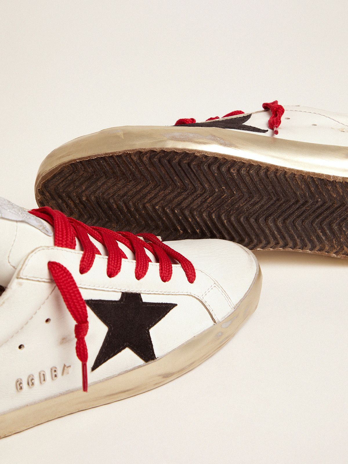 golden goose with red laces