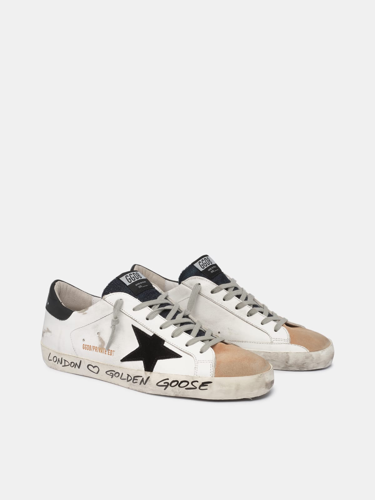 White beige sneakers with handwritten wording Golden Goose