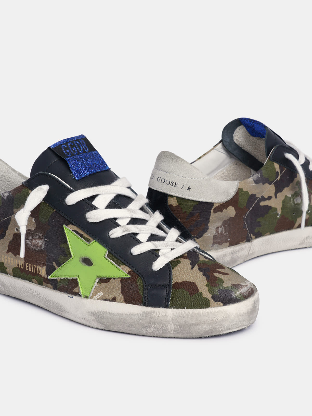 Super Star sneakers with camouflage upper and fluorescent yellow leather star