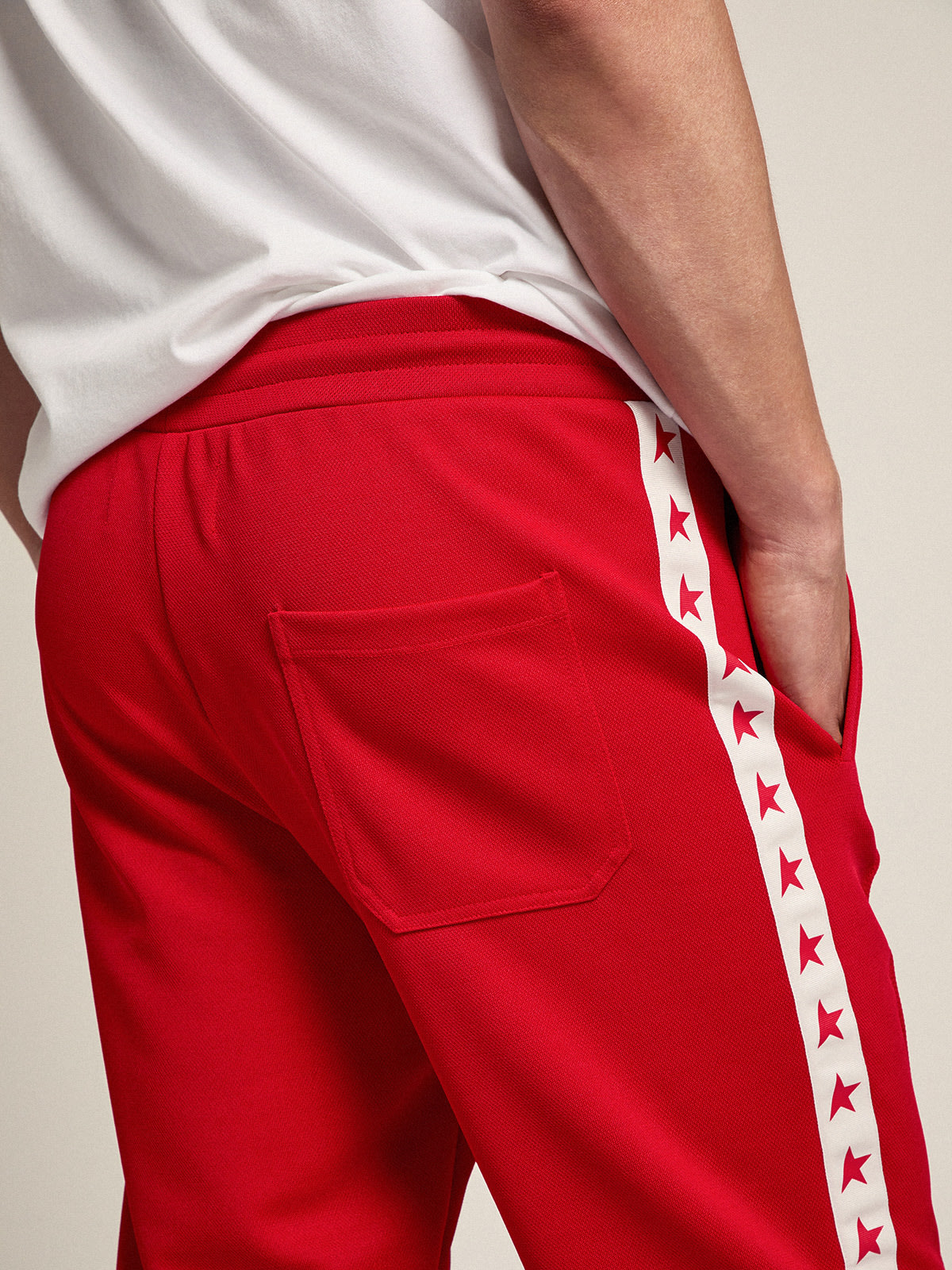 Men's red joggers with stars on the sides