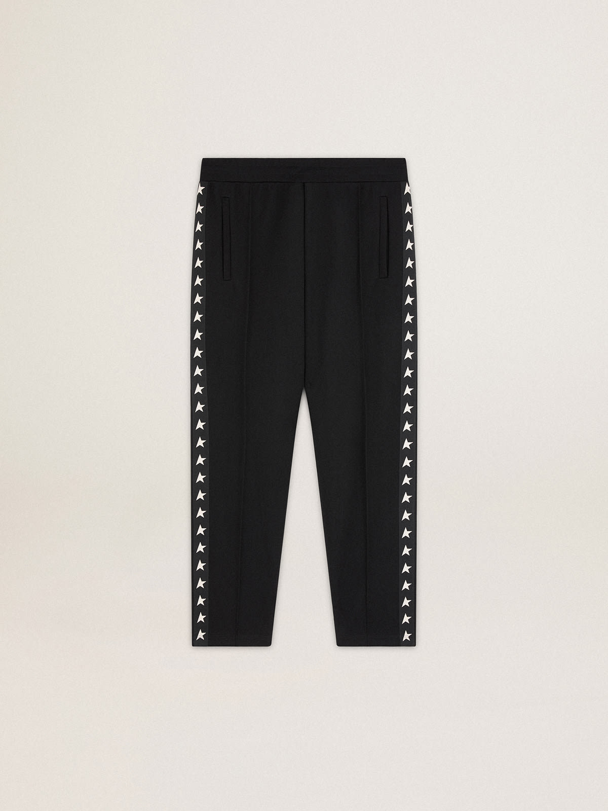 Women's black joggers with white stars on the sides