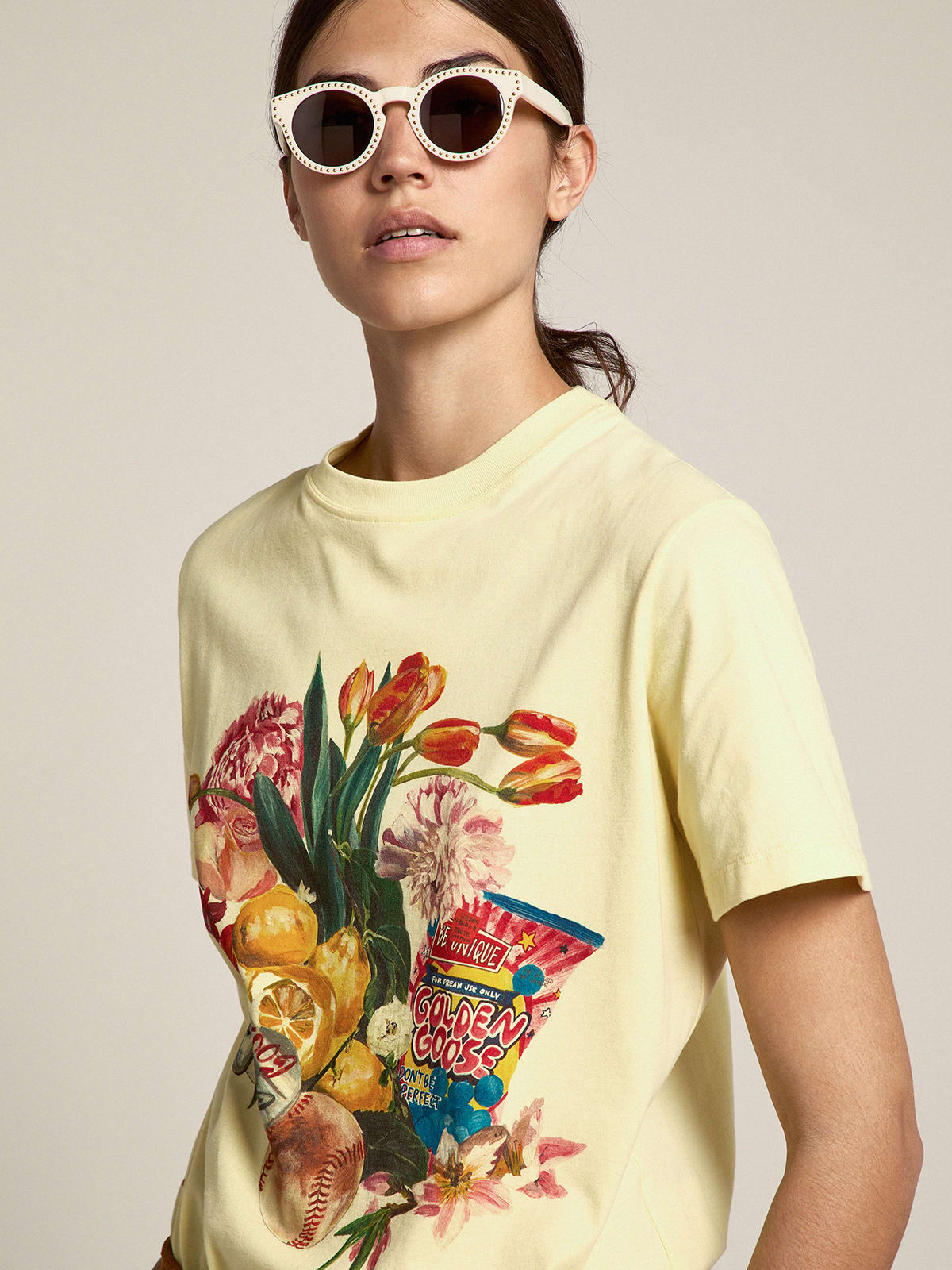 Pastel yellow T-shirt with colorful collage-style print