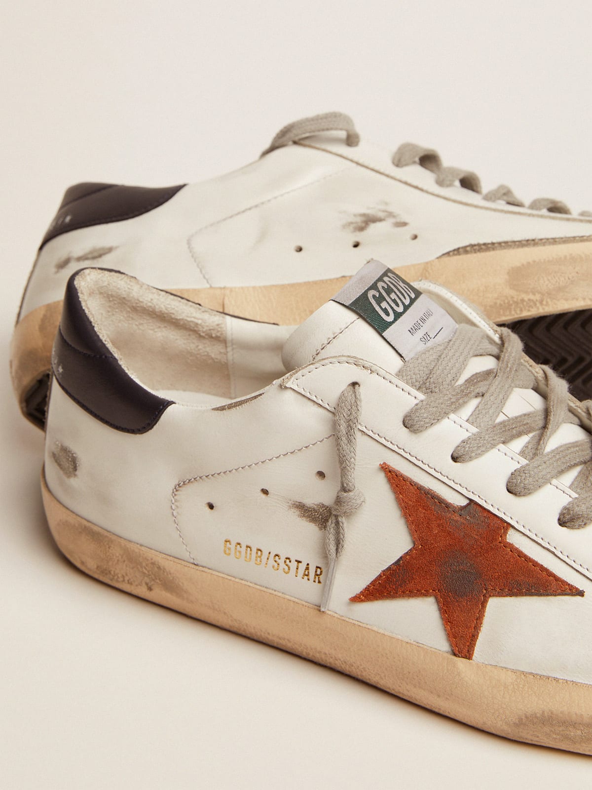 Super-Star with orange suede star and dark blue leather heel tab