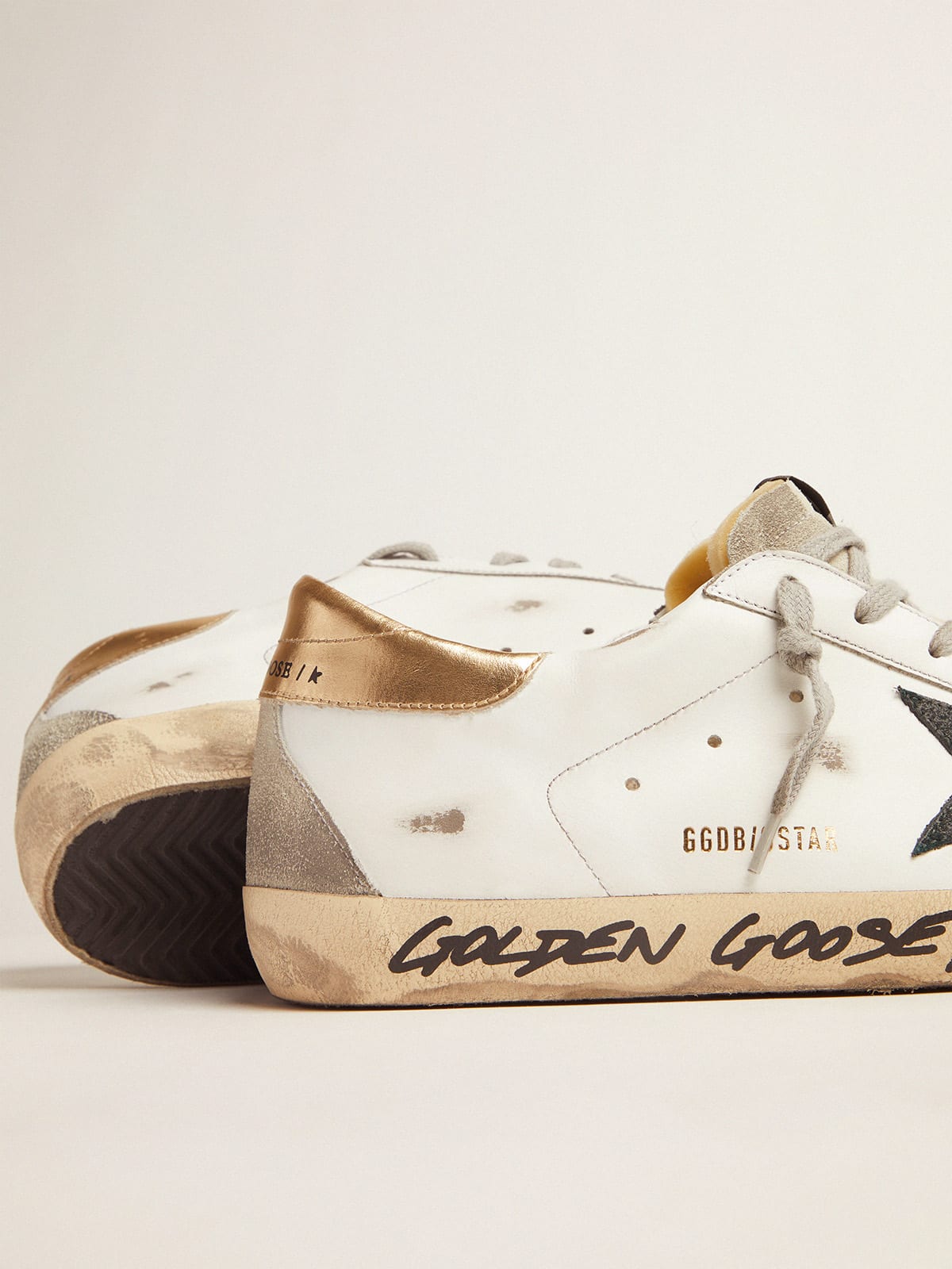 Super-Star sneakers with handwritten Love is all we need lettering