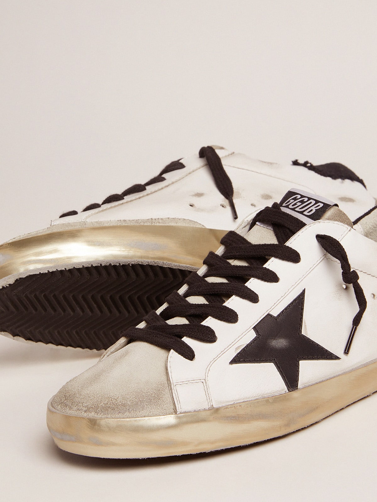 Super-Star sneakers in white leather with black distressed canvas 