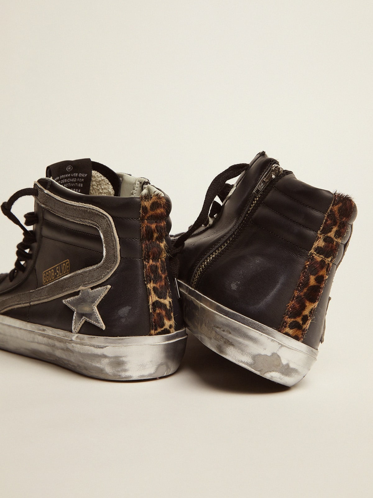 Slide sneakers in black leather with leopard-print pony skin heel tab |  Golden Goose