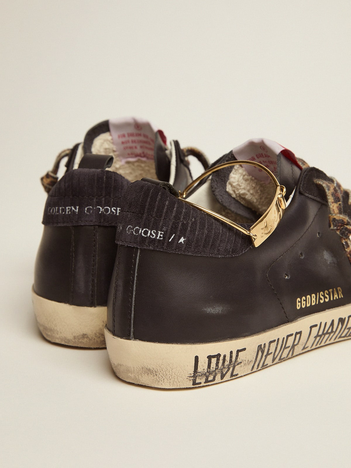 Golden Goose - Super-Star sneakers with black upper and gold ankle guard in 