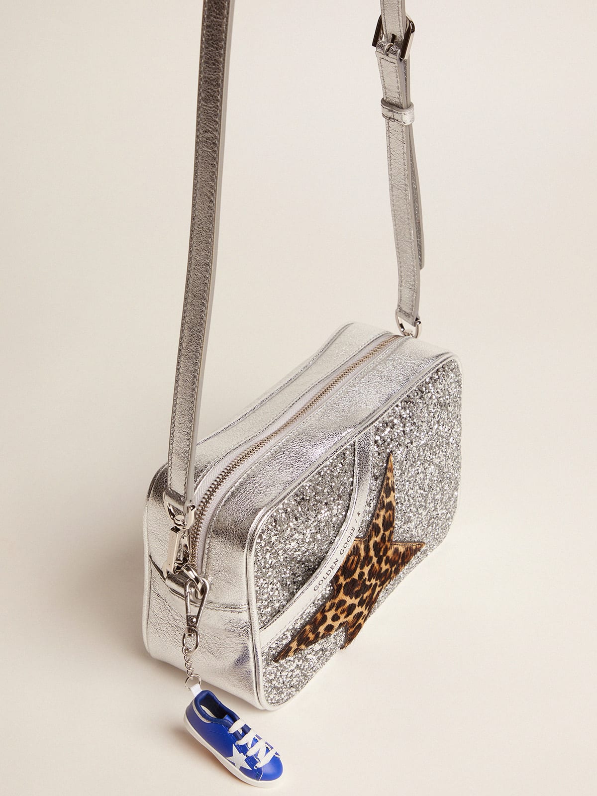 Star Bag in laminated leather with silver glitter and star in leopard-print  pony skin.