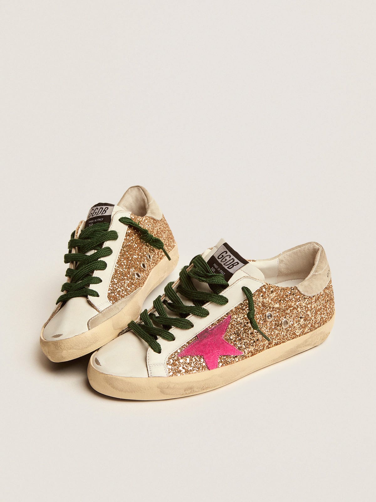Super-Star sneakers in gold glitter with fluorescent pink suede star |  Golden Goose