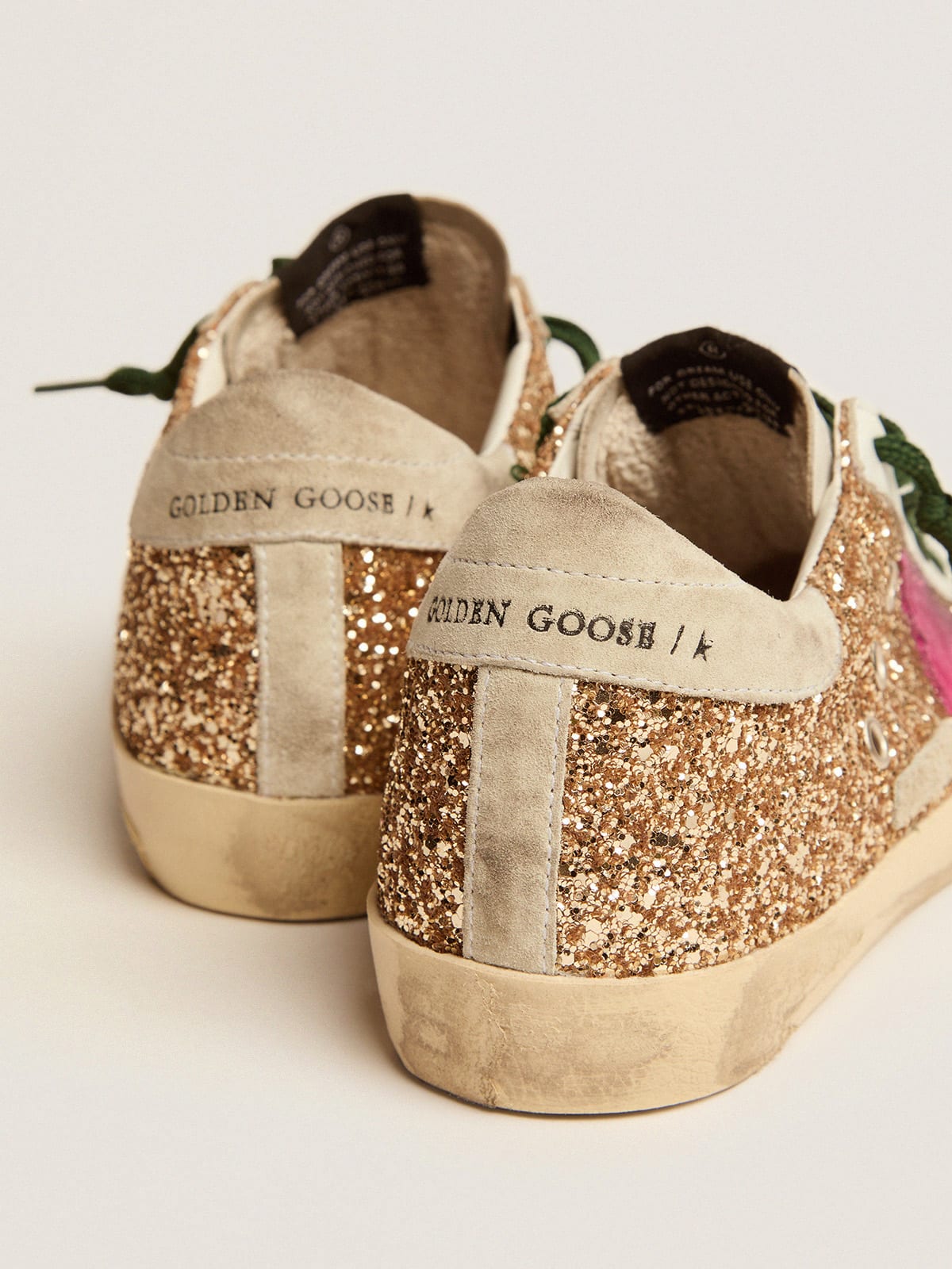 Super-Star sneakers in gold glitter with fluorescent pink suede star |  Golden Goose