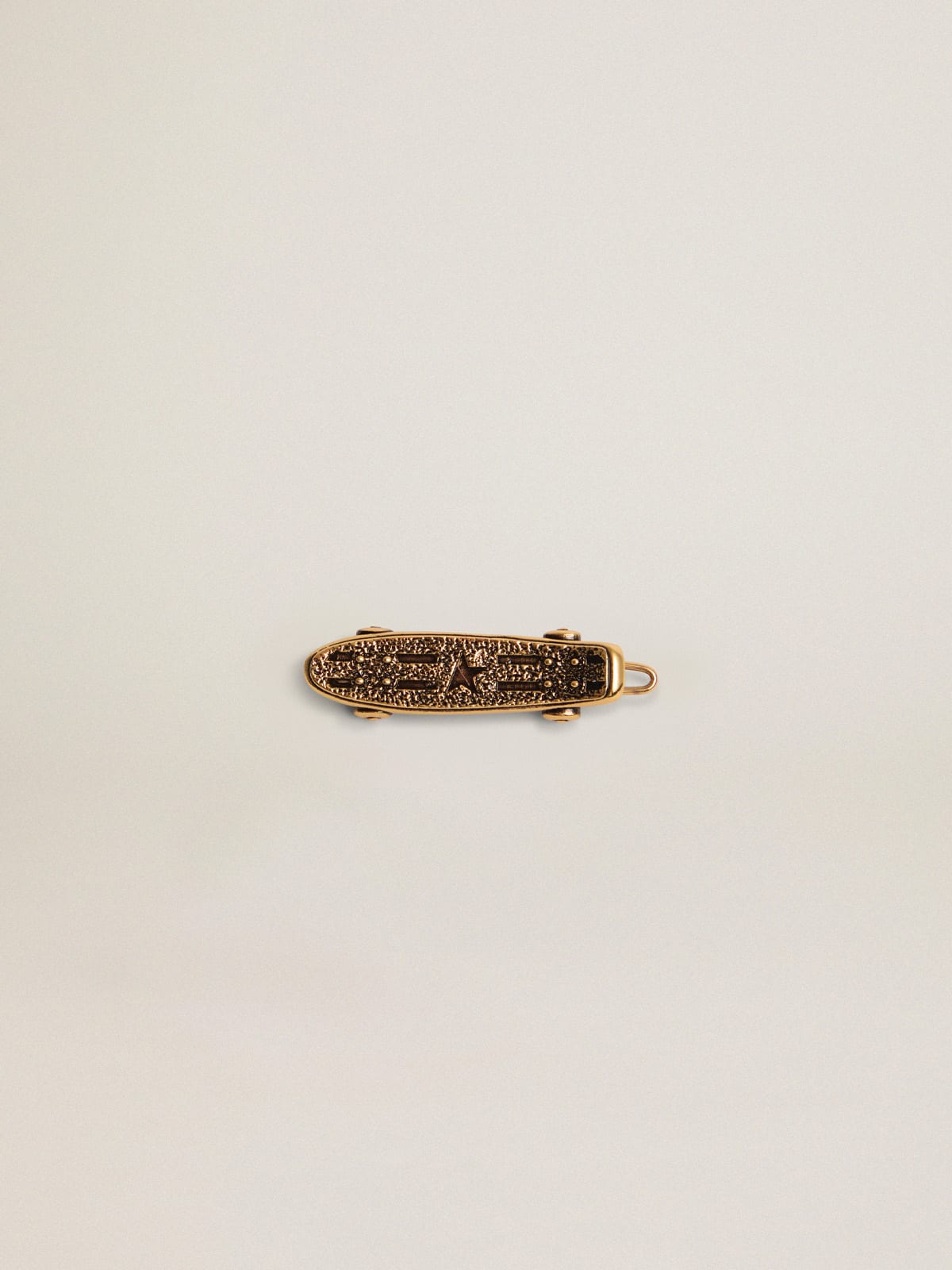 Golden Goose - Timeless Jewelmates Collection lace accessory in old gold color in the shape of a skateboard in 
