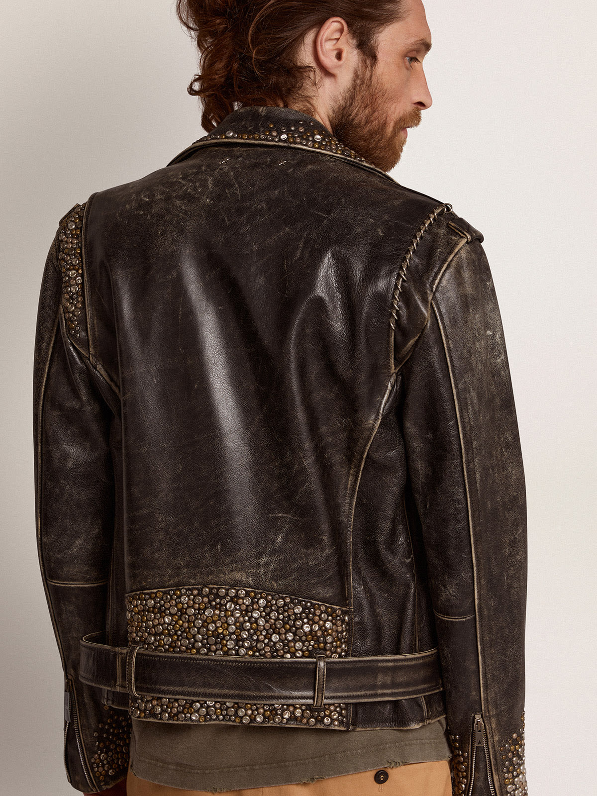 Men s leather biker jacket with hammered studs and adhesive tape