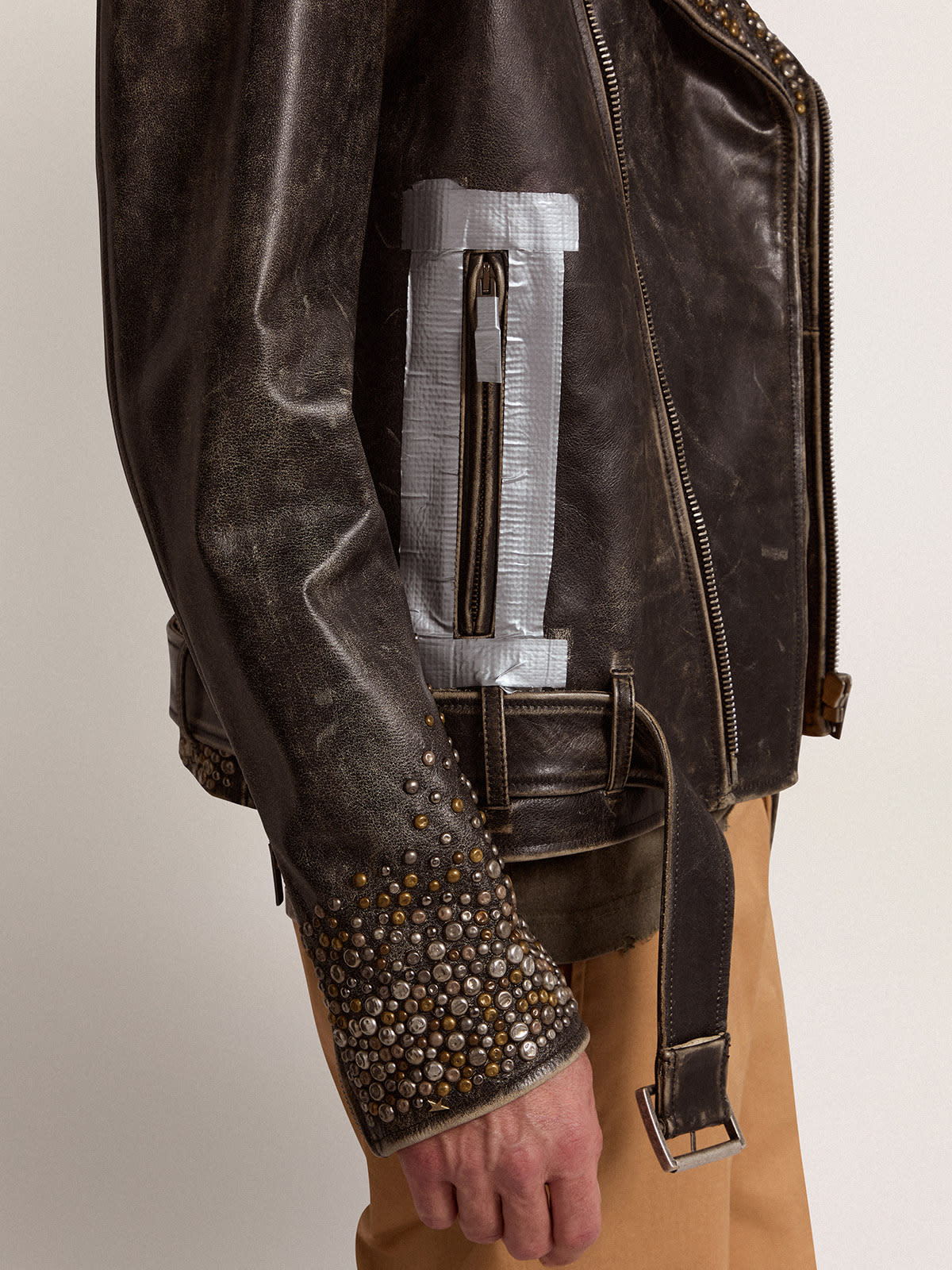 Men s leather biker jacket with hammered studs and adhesive tape