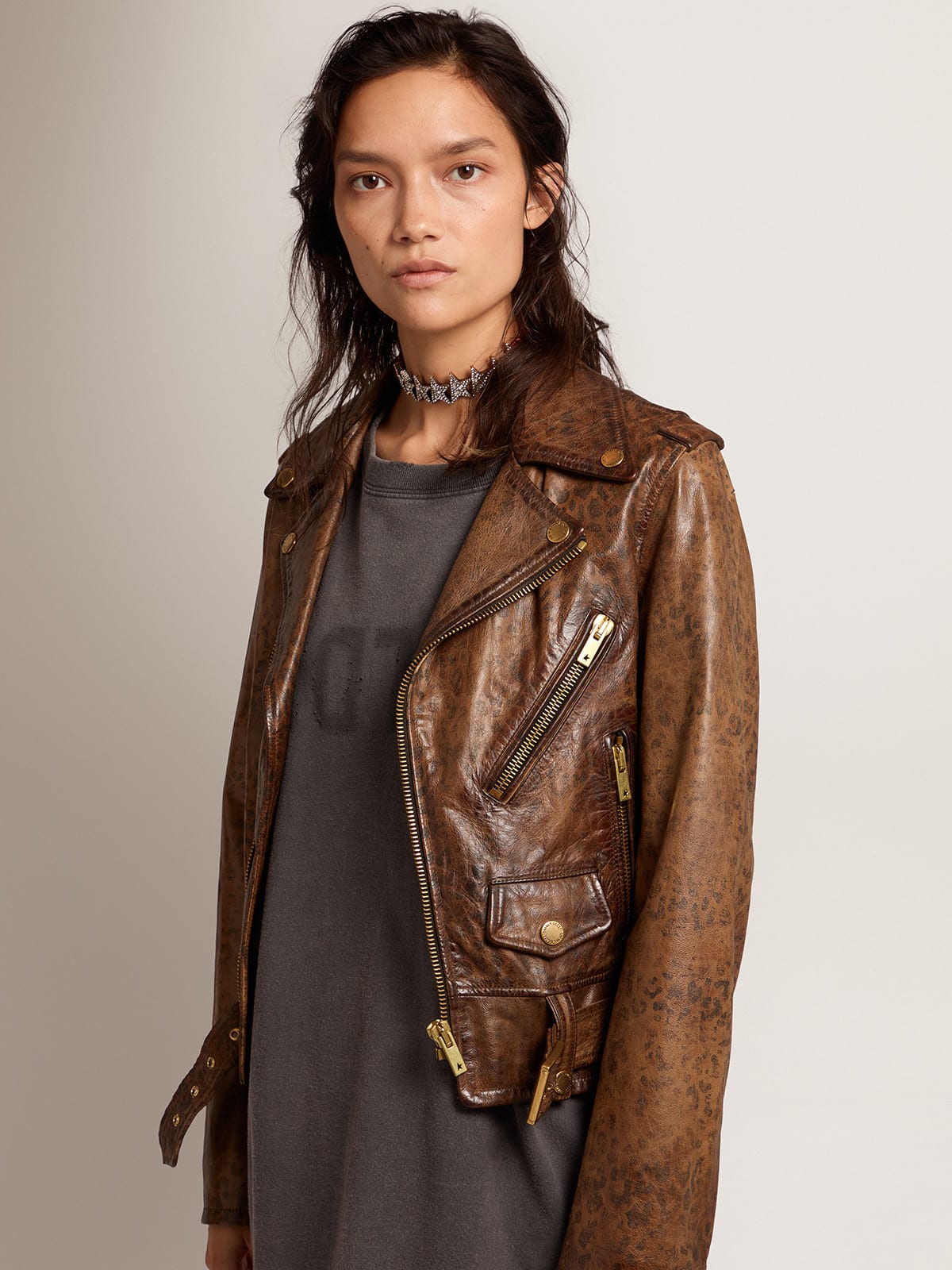 Women's distressed leather biker jacket with animal print