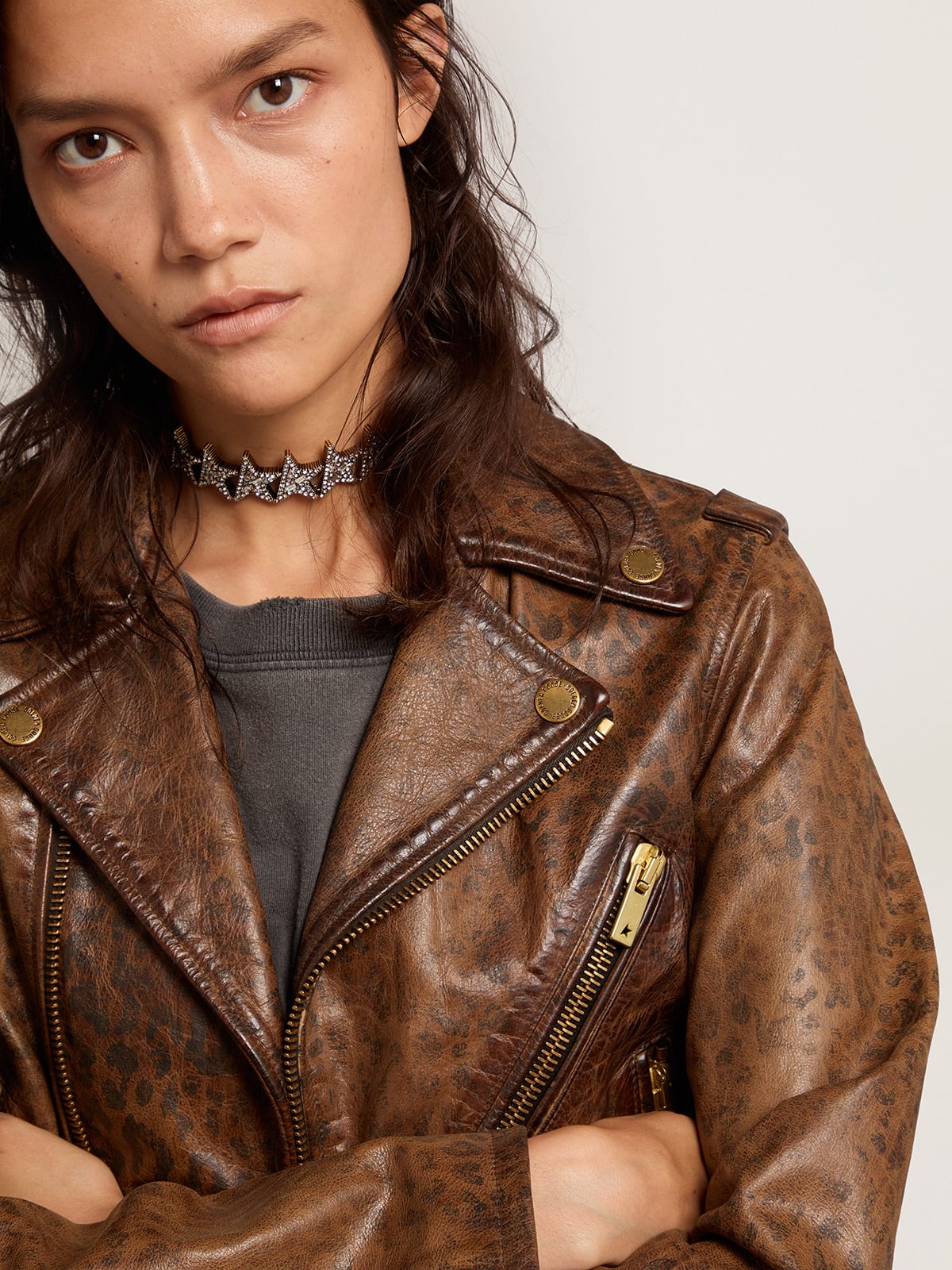 Women's distressed leather biker jacket with animal print