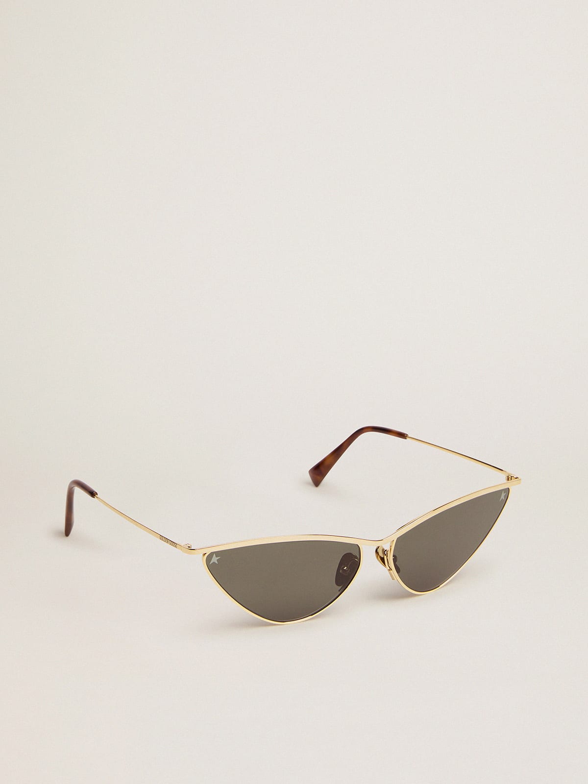 Sunglasses cat-eye style with gold frame and green lenses