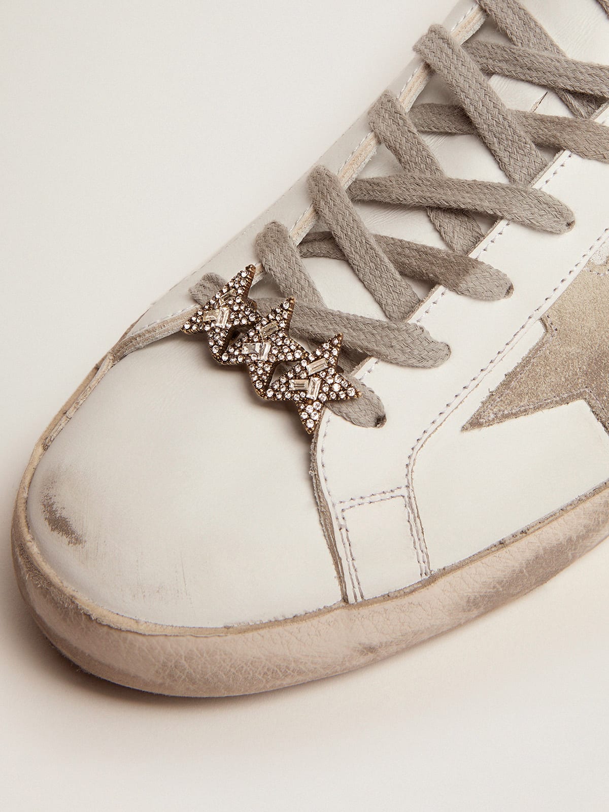 Lace accessory with three old gold color stars with crystals