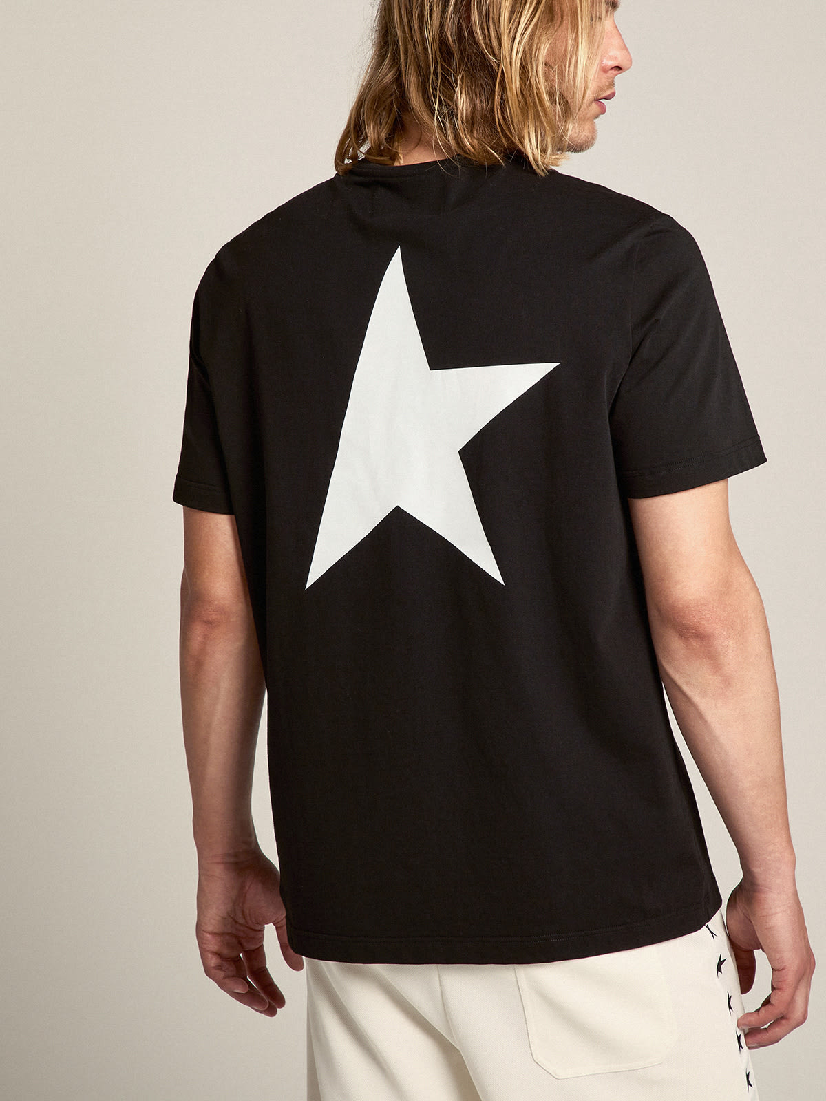 Men s black T shirt with contrasting white logo and star