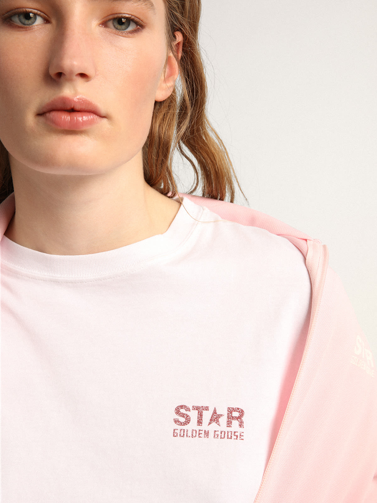 Women's white T-shirt with pink glitter logo and star