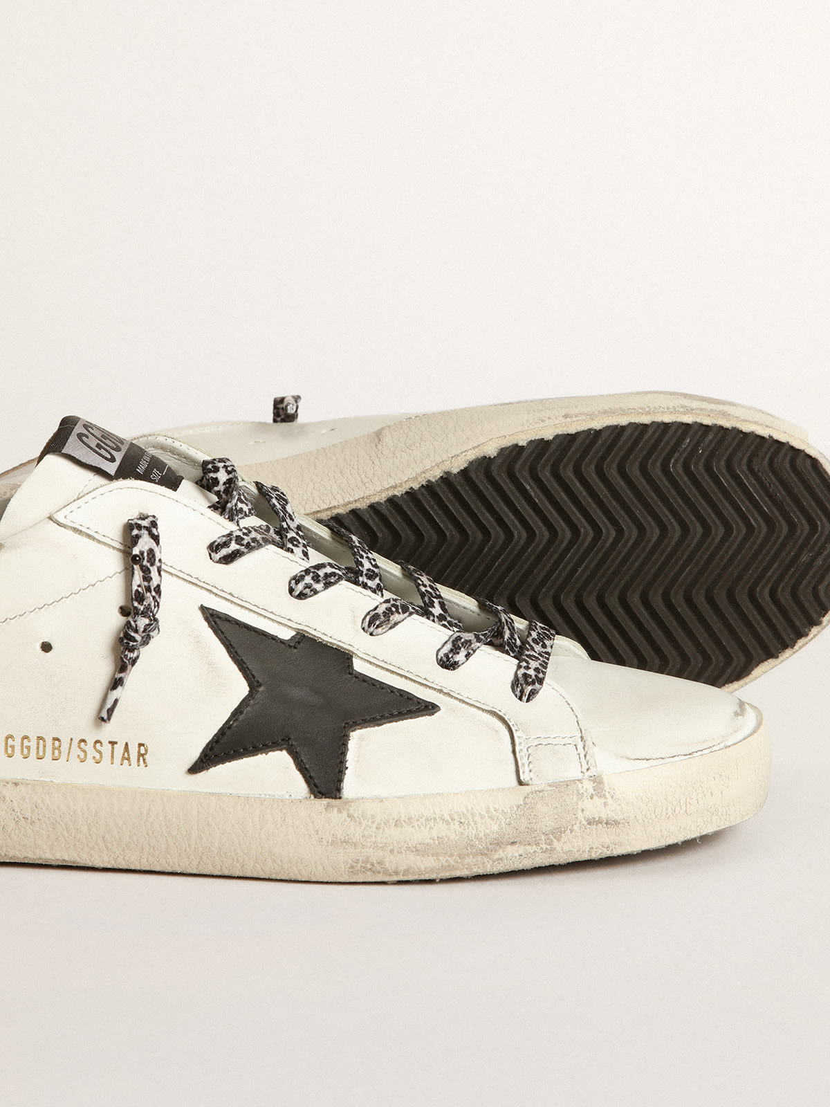 White Super-Star sneakers with black star and leopard-print laces