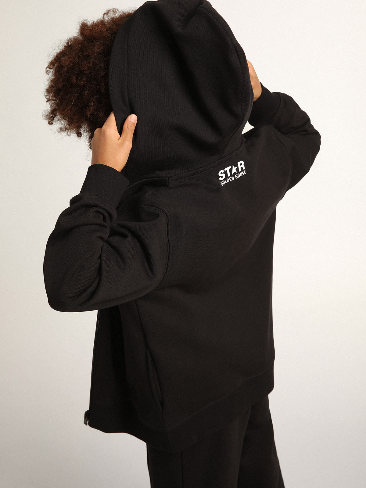 Black hooded sweatshirt with contrasting white star and logo