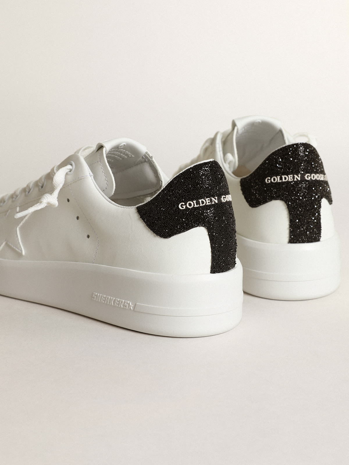 Golden goose black sales and white sneakers