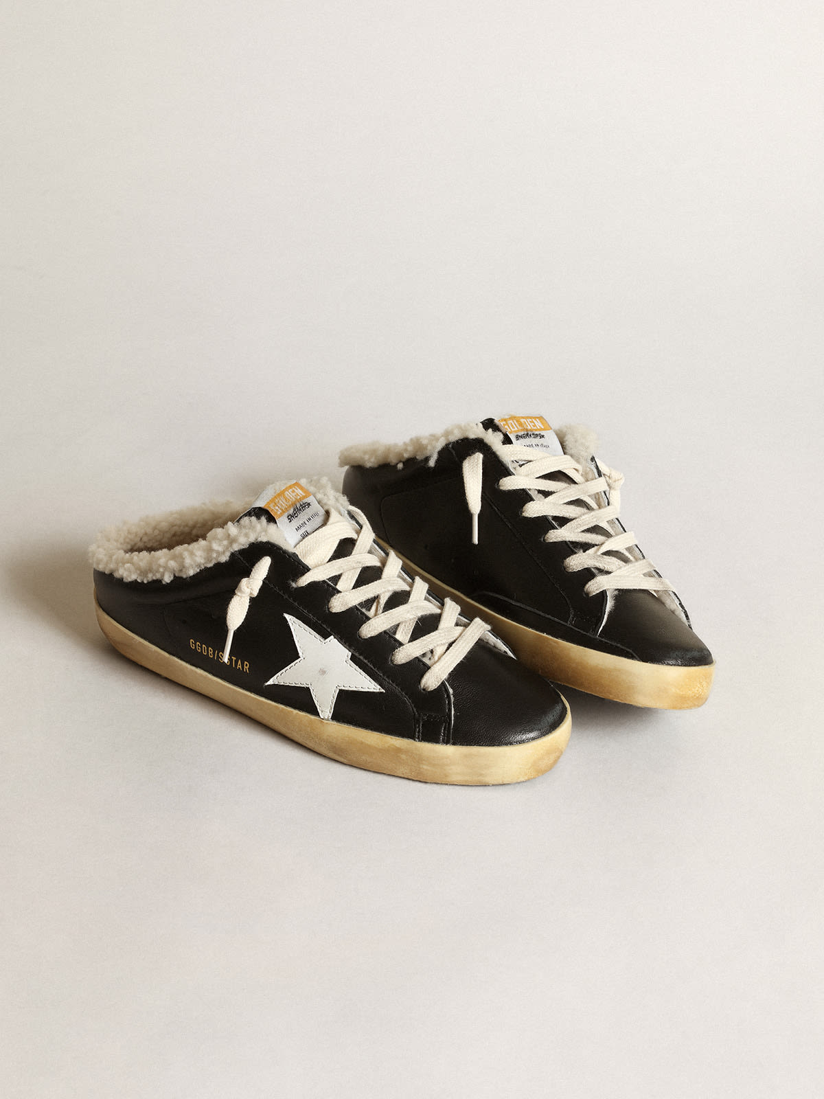 Super-Star Sabots in black nappa leather with white leather star and beige shearling  lining | Golden Goose