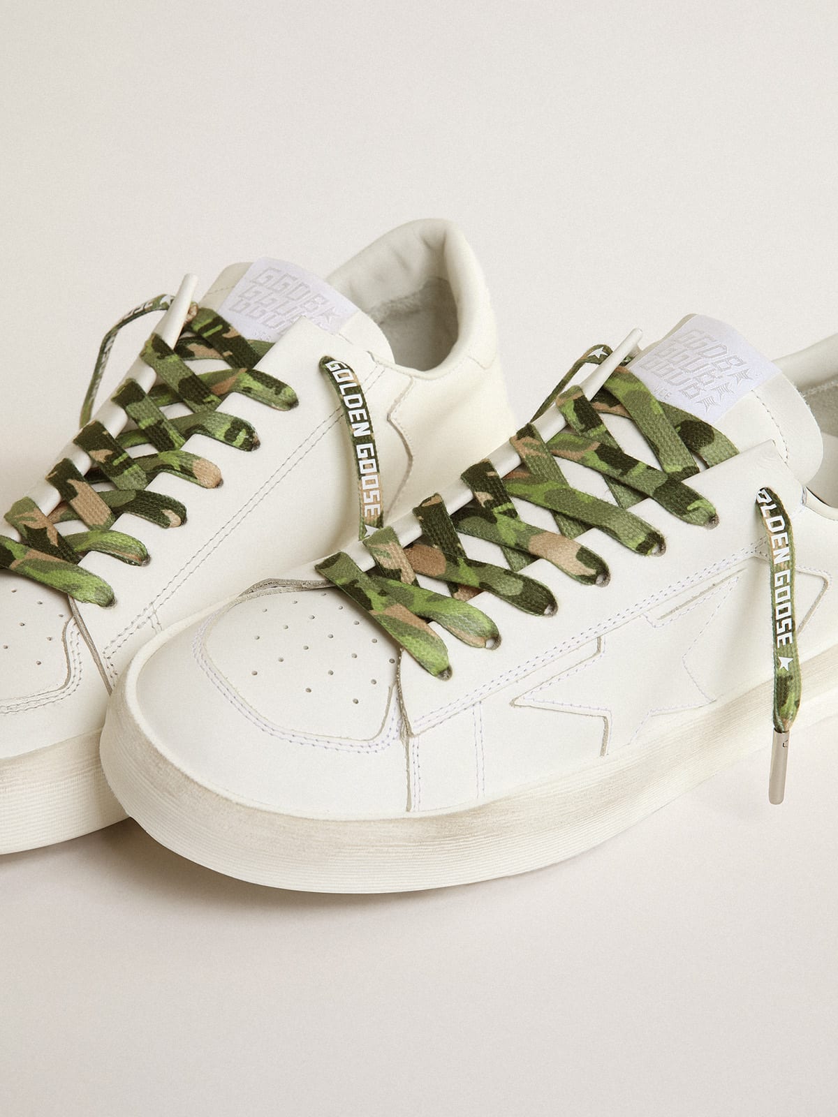 Green camouflage laces with contrasting white logo