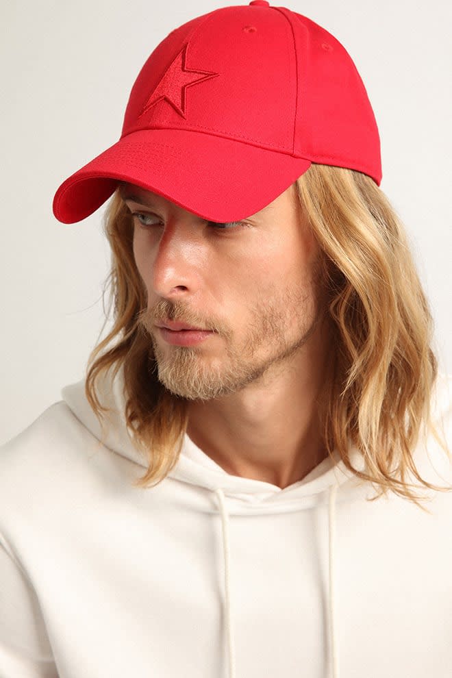 Red cotton baseball cap with tone-on-tone star-shaped patch on the front