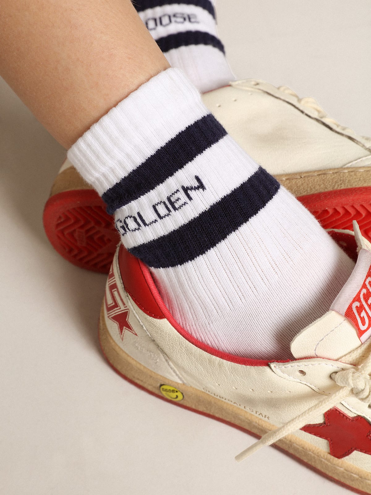 White cotton socks with navy-blue stripes and Golden Goose logo