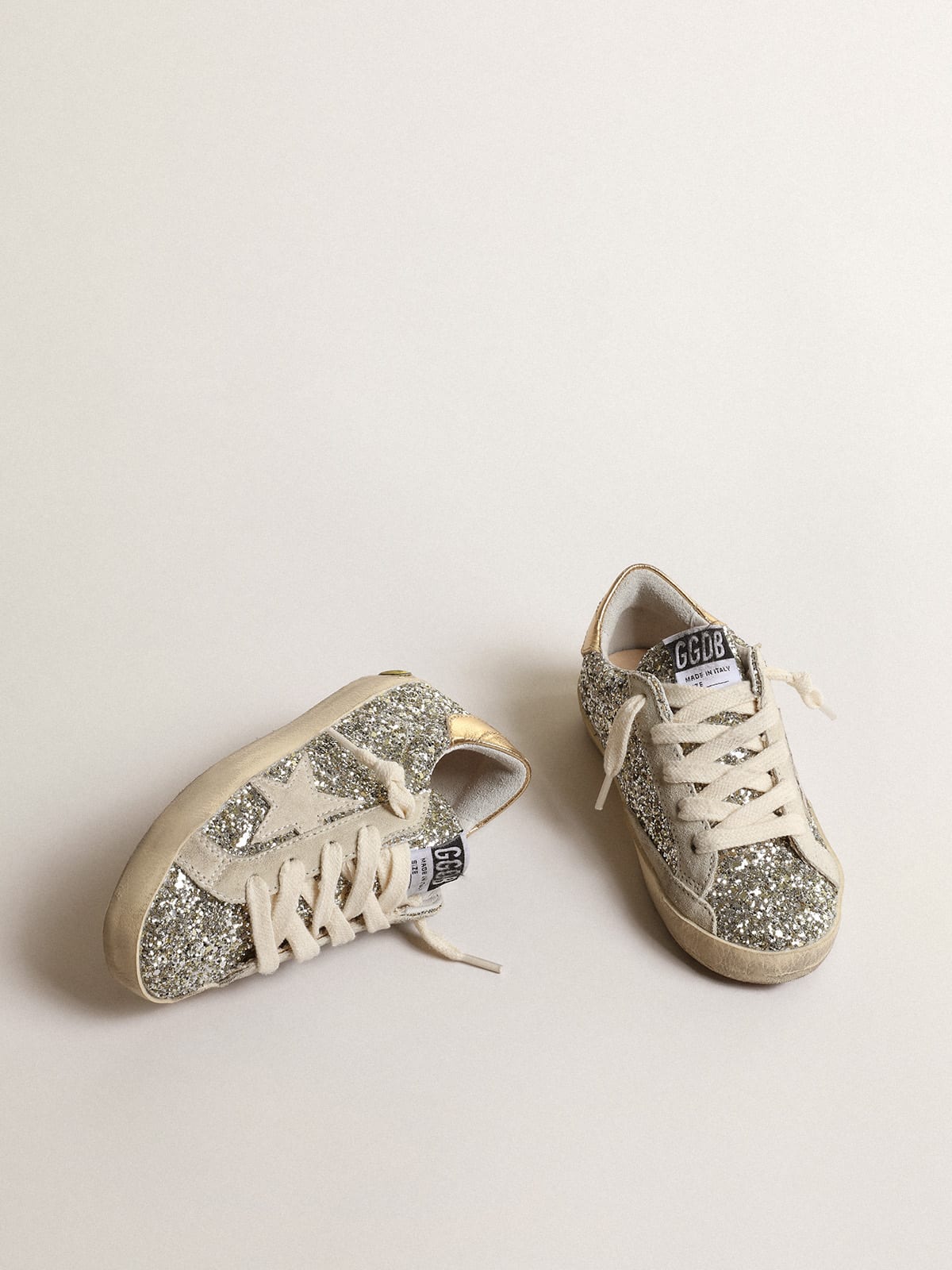 Super Star Young in glitter with a suede star and gold heel tab