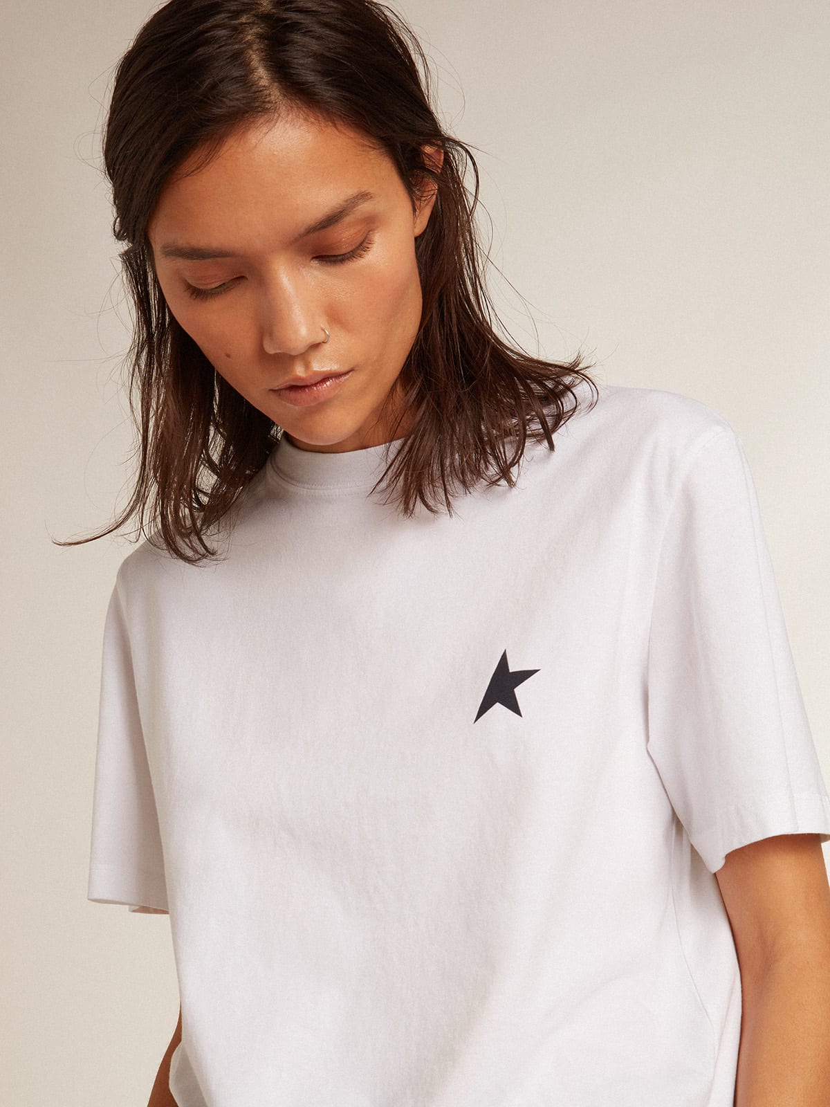 Women’s white T-shirt with dark blue star on the front