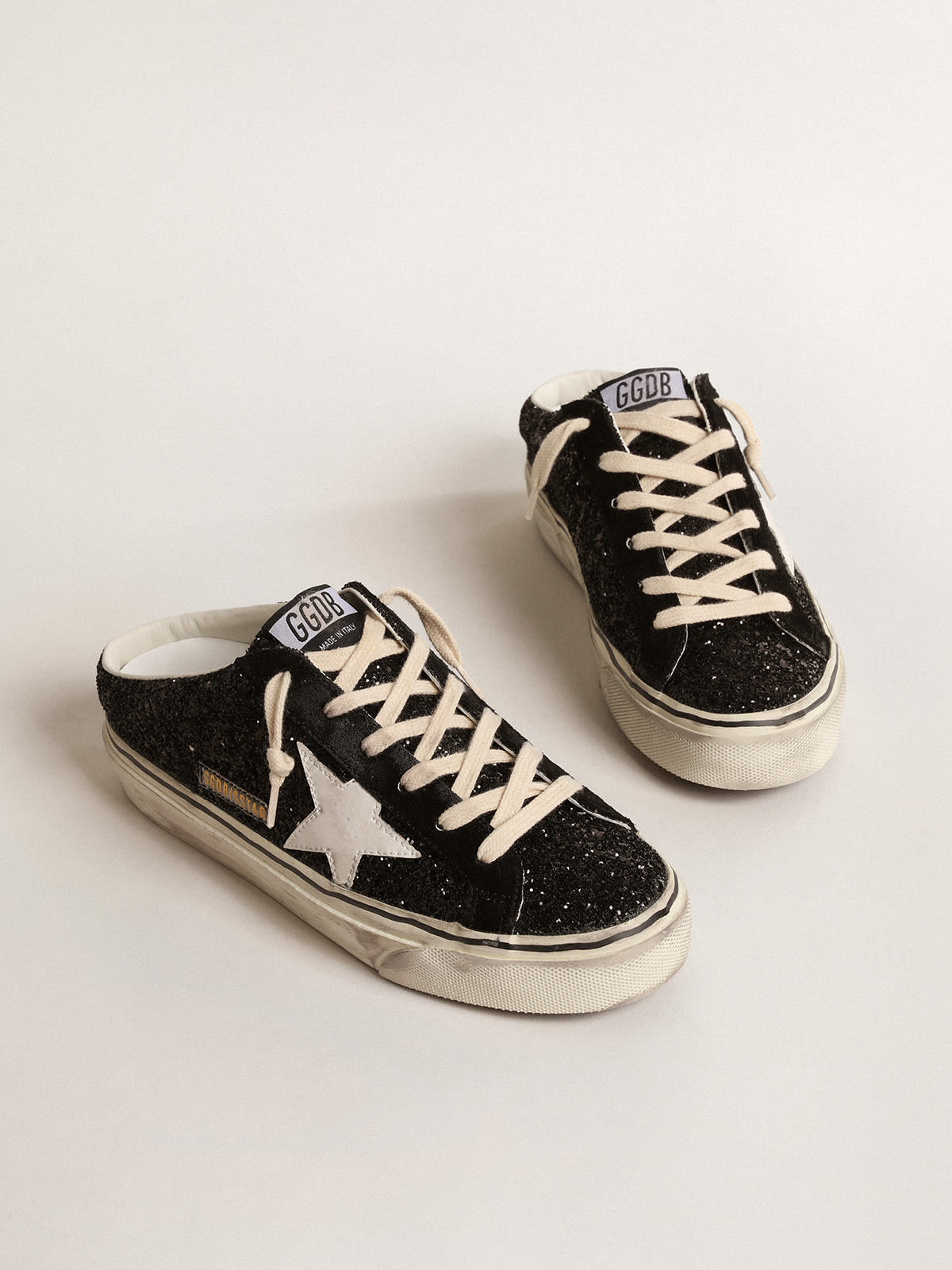 Golden Goose - Super-Star Sabots in black glitter with white bio-based star in 