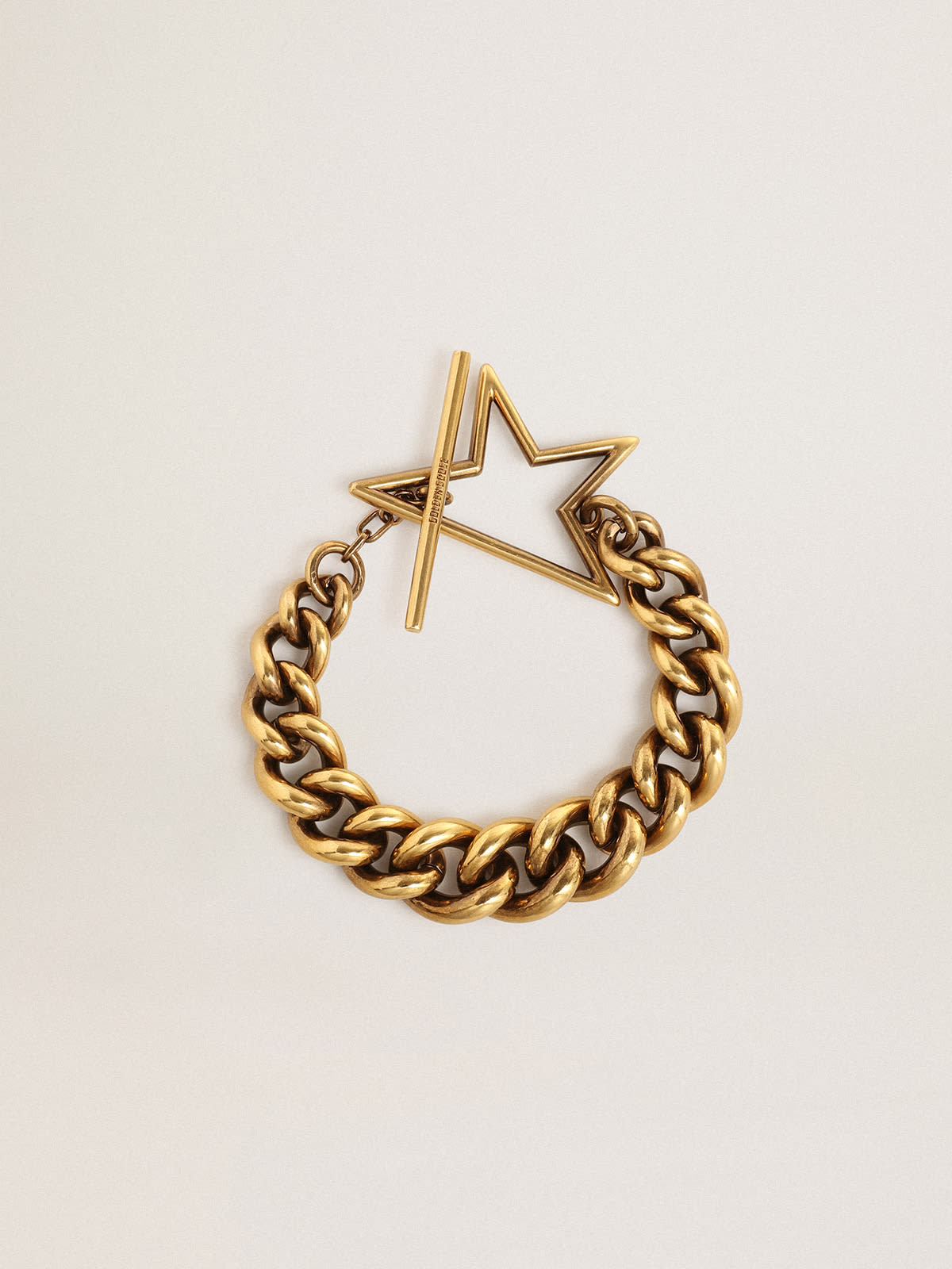 Bracelet in old gold decreasing chain with star-shaped clasp