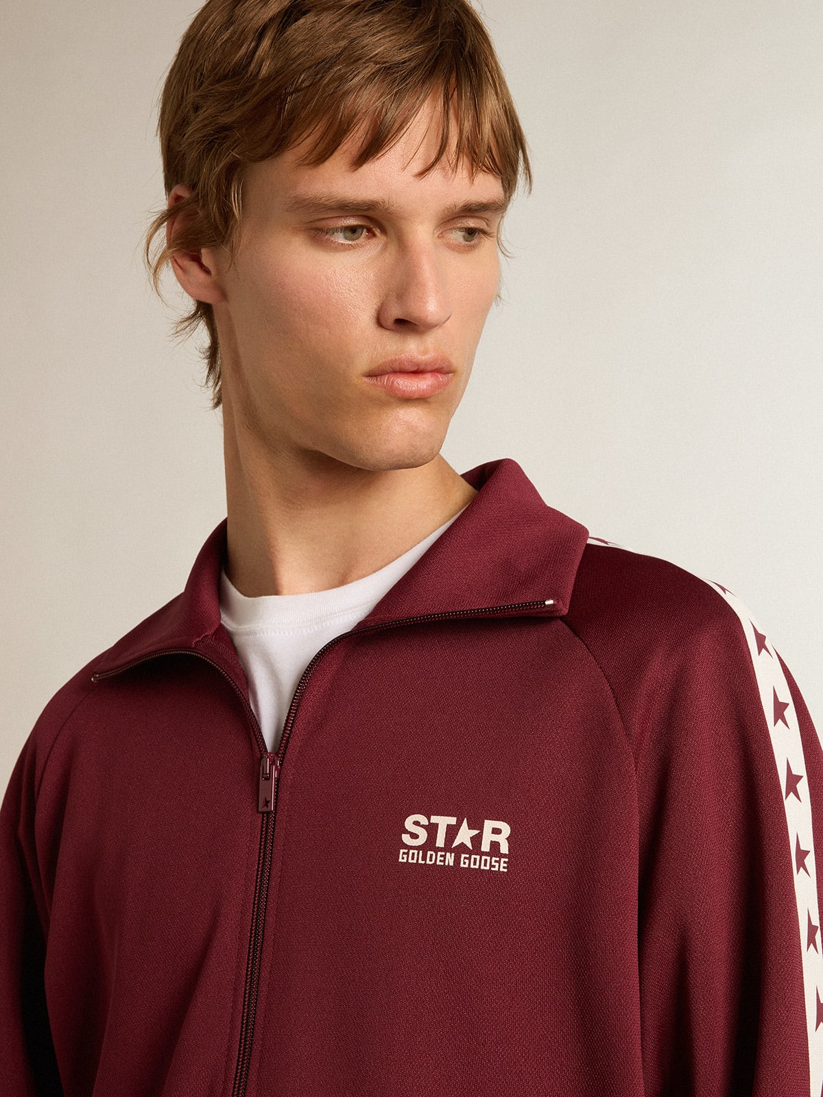 Men s burgundy zipped sweatshirt with white strip and contrasting stars