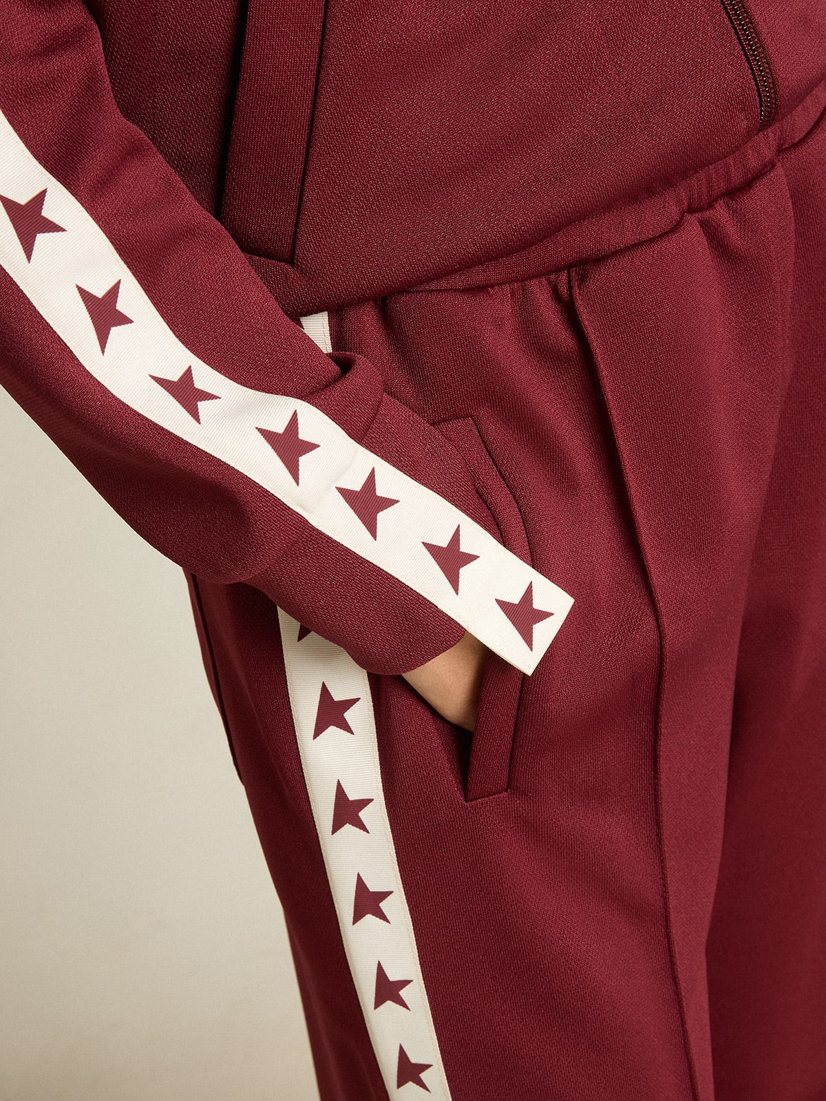 Women's red joggers with stars on the sides