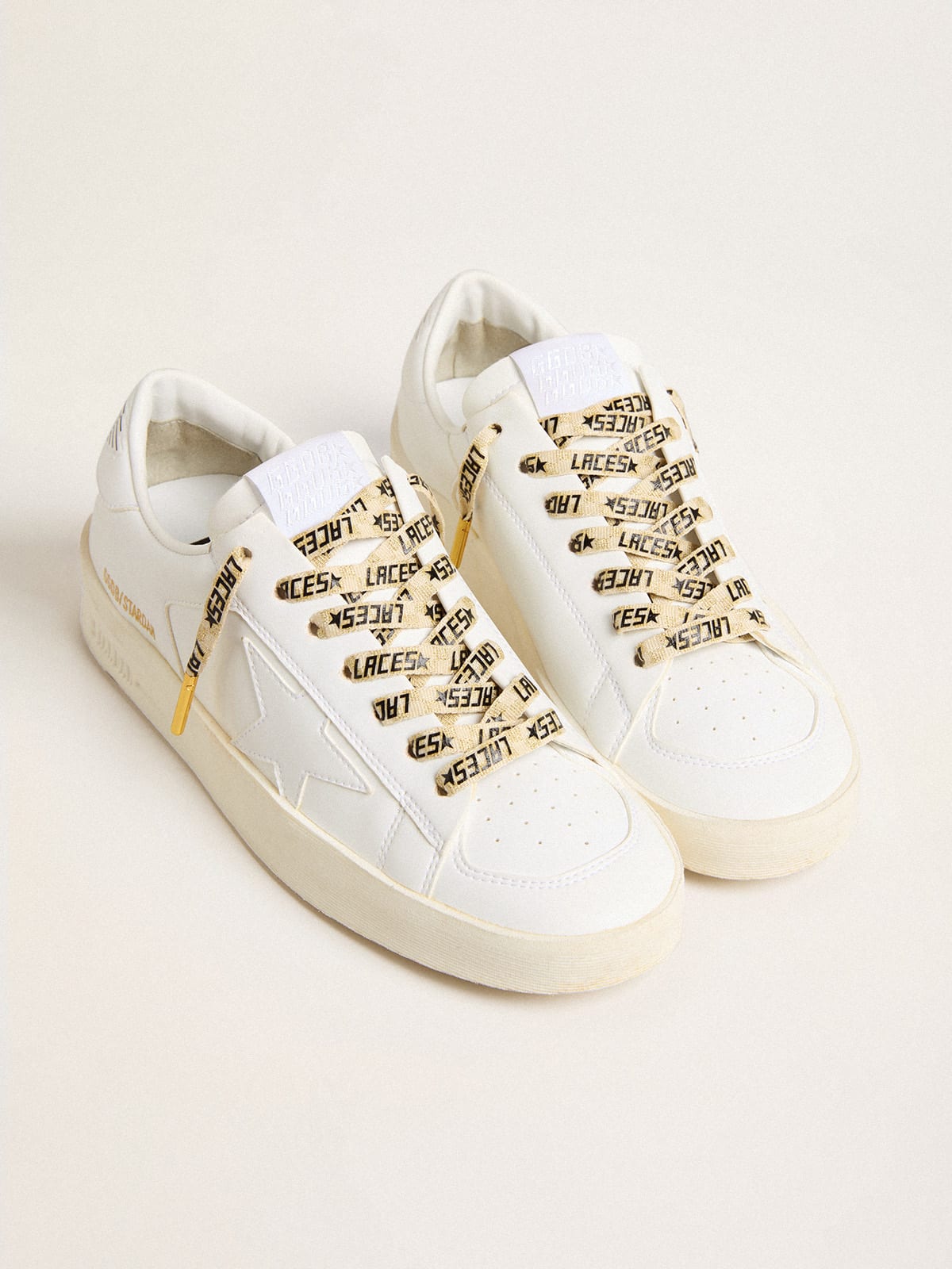 Gold-colored cotton laces with black Laces lettering